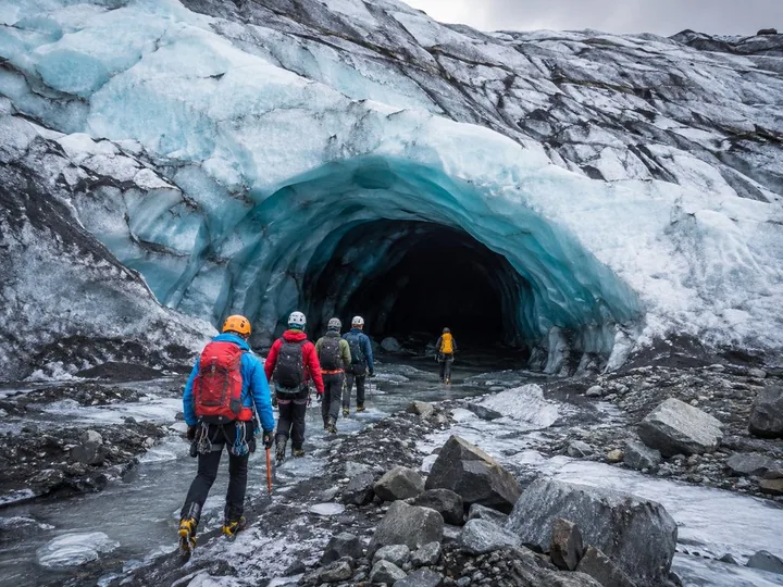 Cave entrance under the overhanging glacier ice